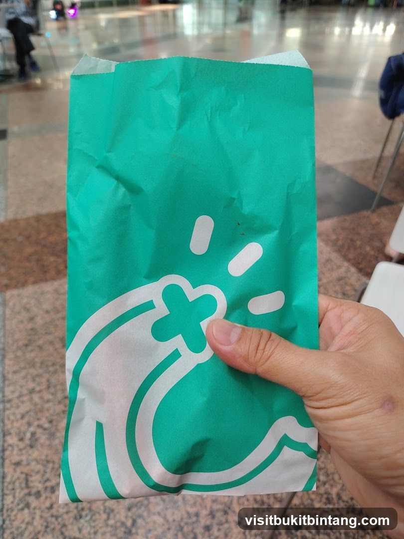 Green paper bag with white logo