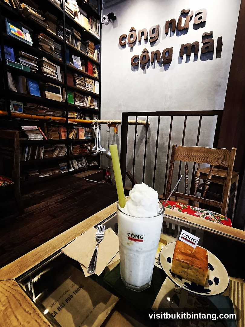 Coffee shop interior with books and a drink