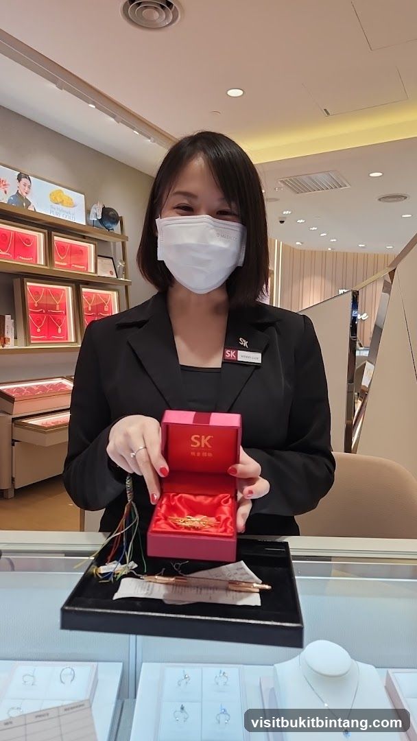 Jewelry Store Employee Presenting a Gold Brooch