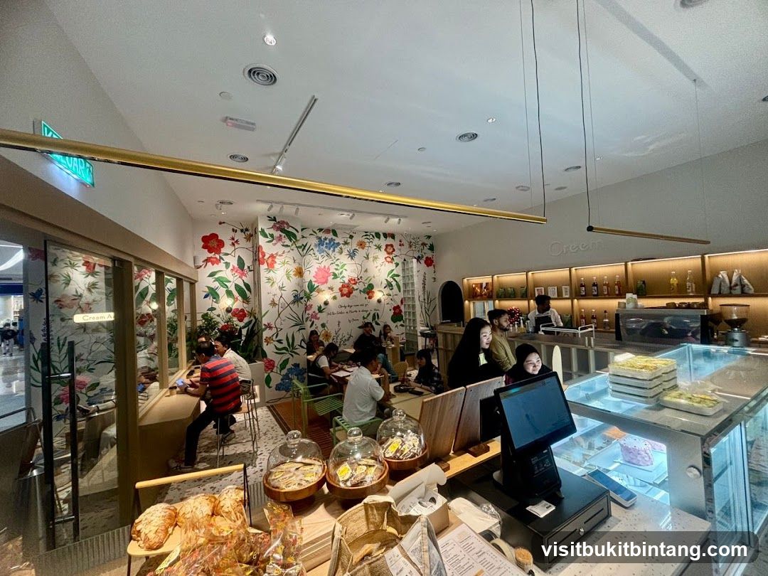 Interior of a cafe with floral wallpaper and display cases