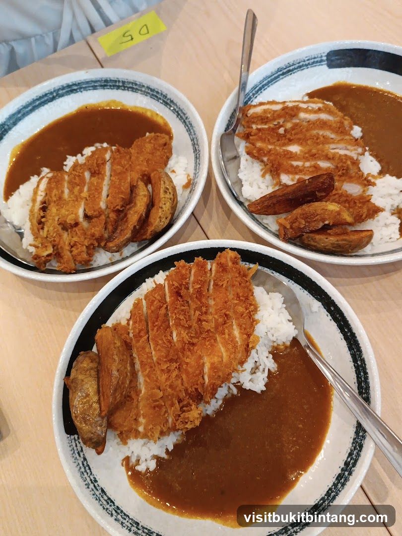 Three plates of katsu curry