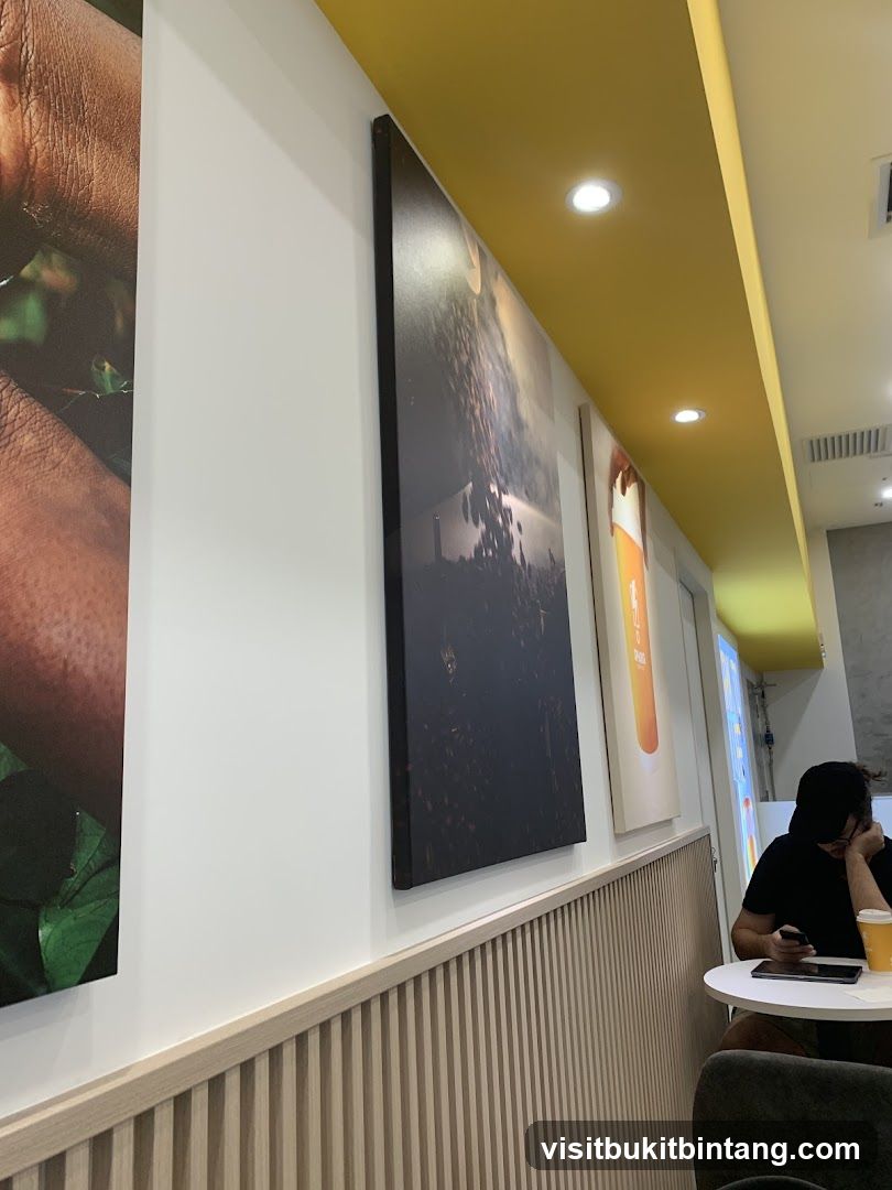 Interior of a cafe with artwork and a customer
