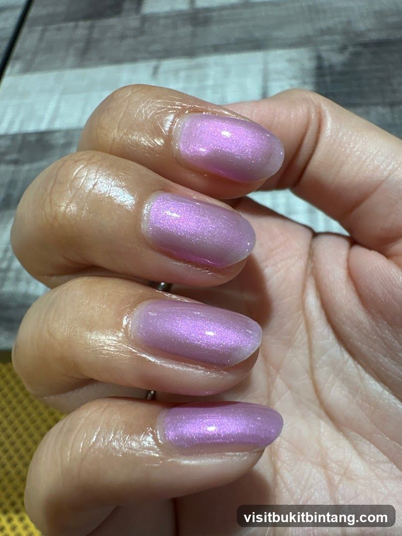 Close-up of a hand with lavender-colored nails