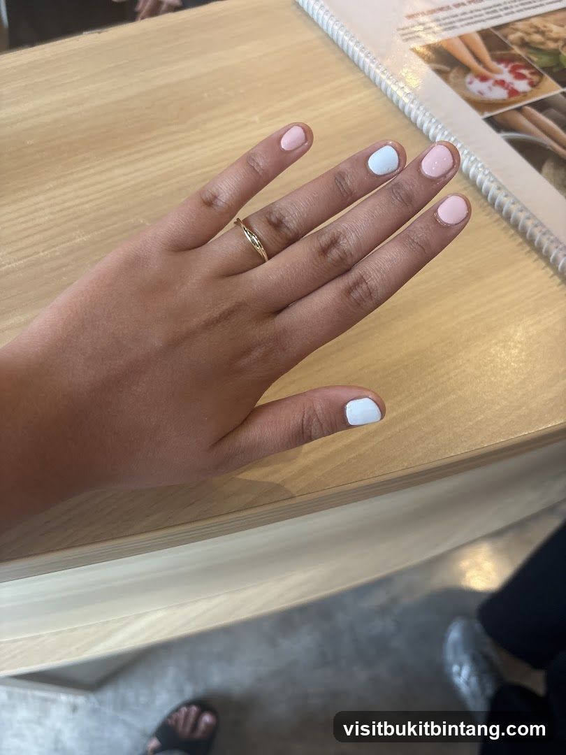 Hand with painted nails on a table