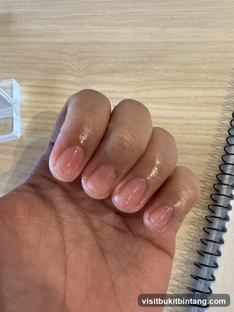 Hand with clear nail polish