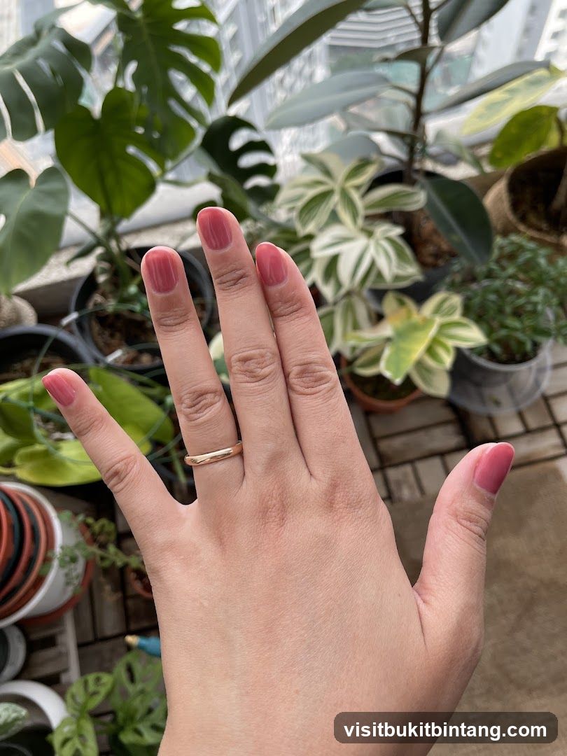 Hand with Ring and Pink Nail Polish