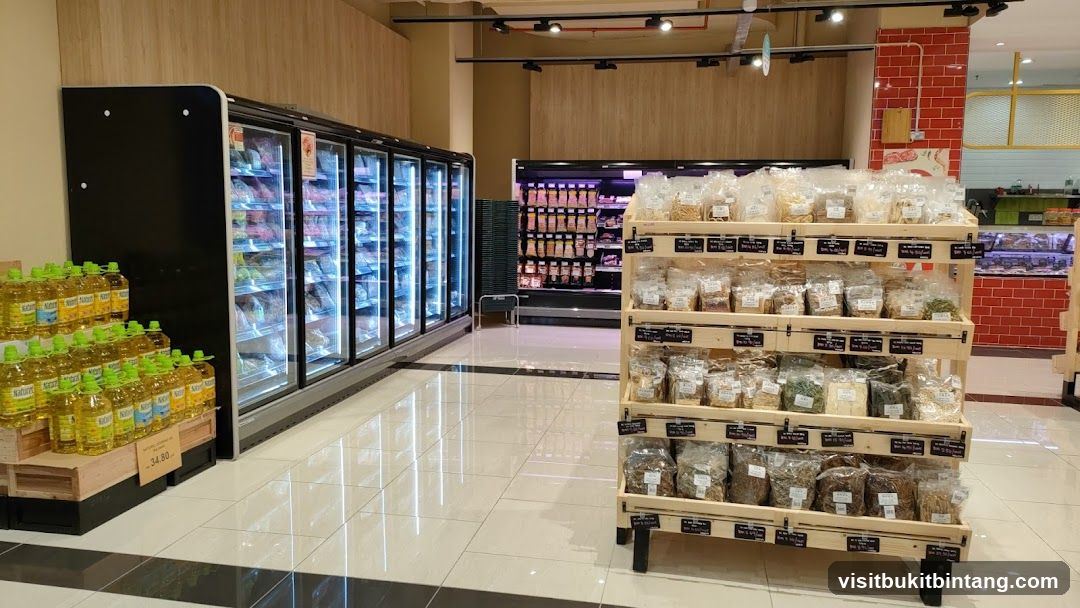 Supermarket aisle with refrigerated displays and shelves of packaged goods