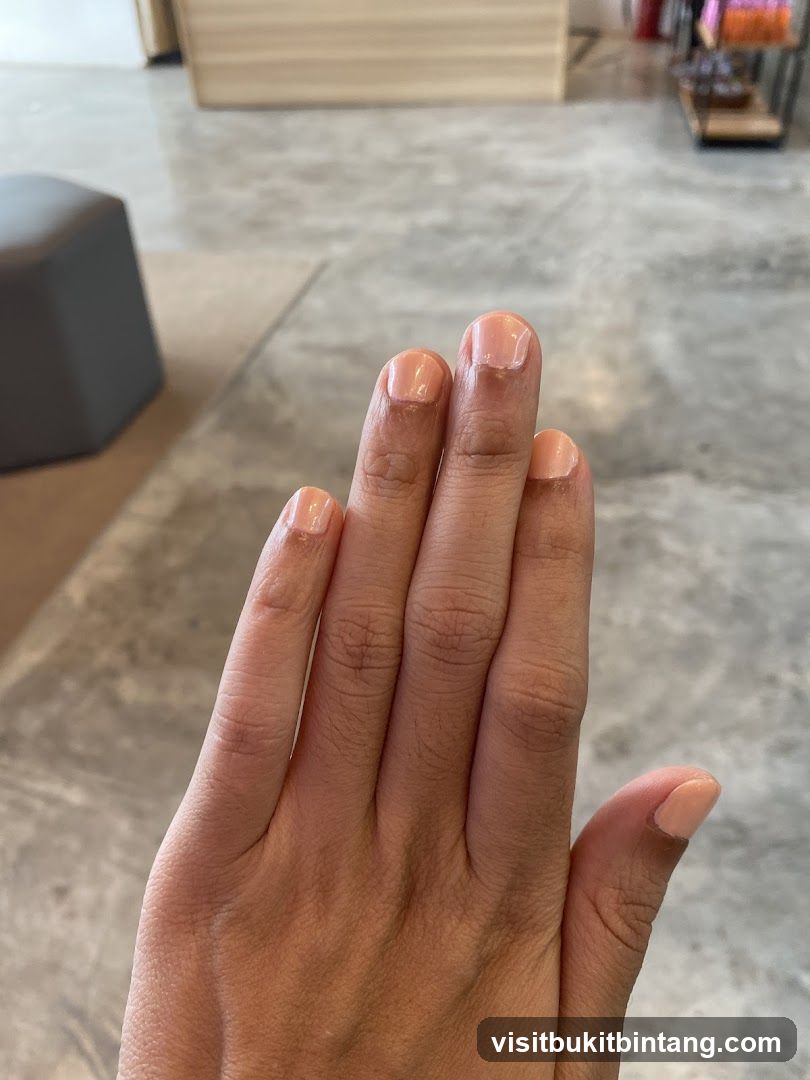 Hand with light pink nails