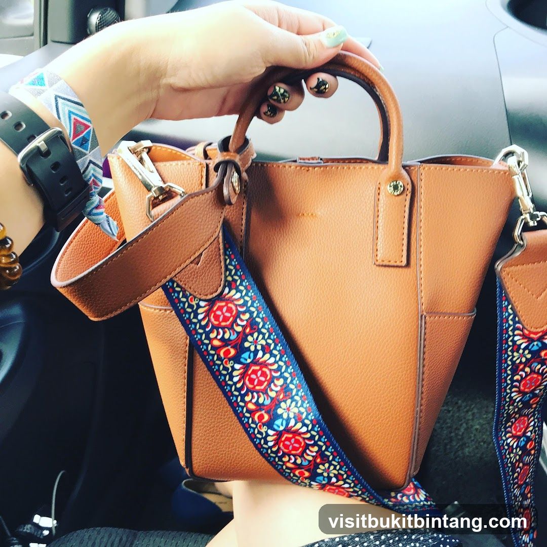 Woman Holding a Brown Handbag