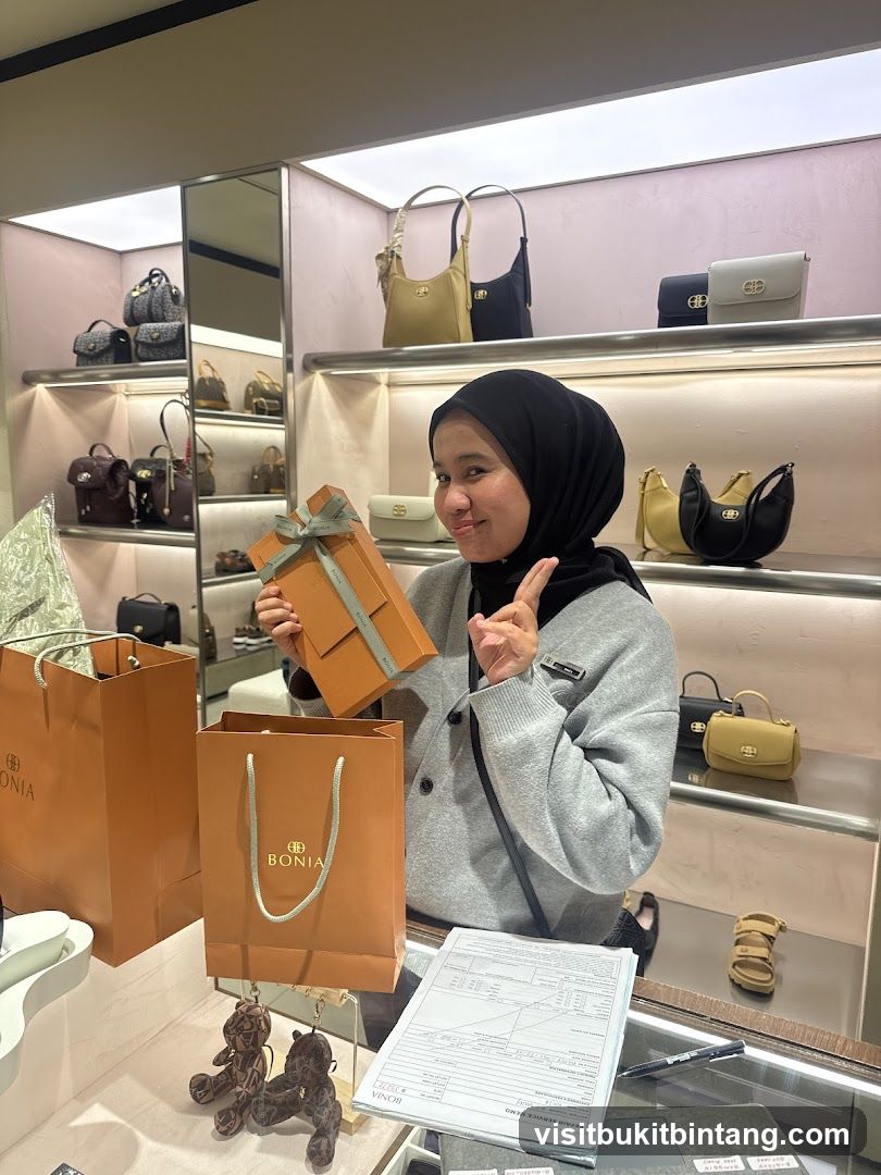 Woman holding a gift box in a handbag store