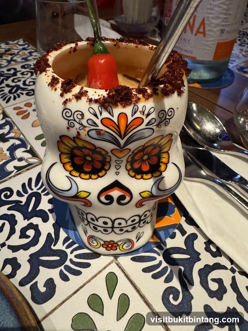 Skull-shaped mug with chili pepper