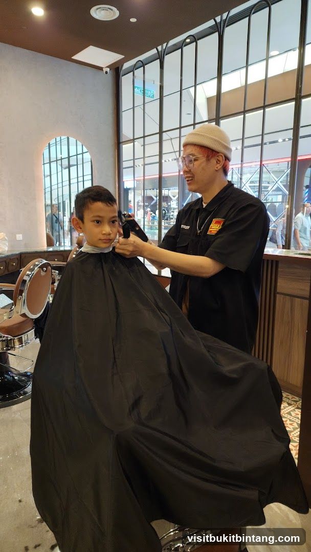 Barber cutting boy's hair