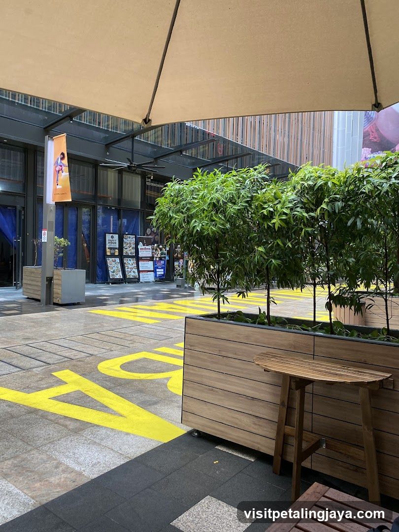 Outdoor seating area with planters and storefront entrance