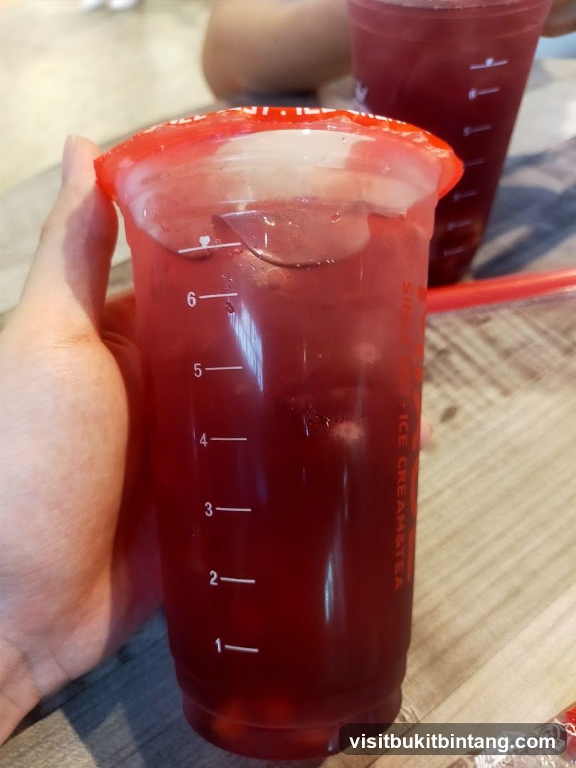 Red Drink in a Branded Cup