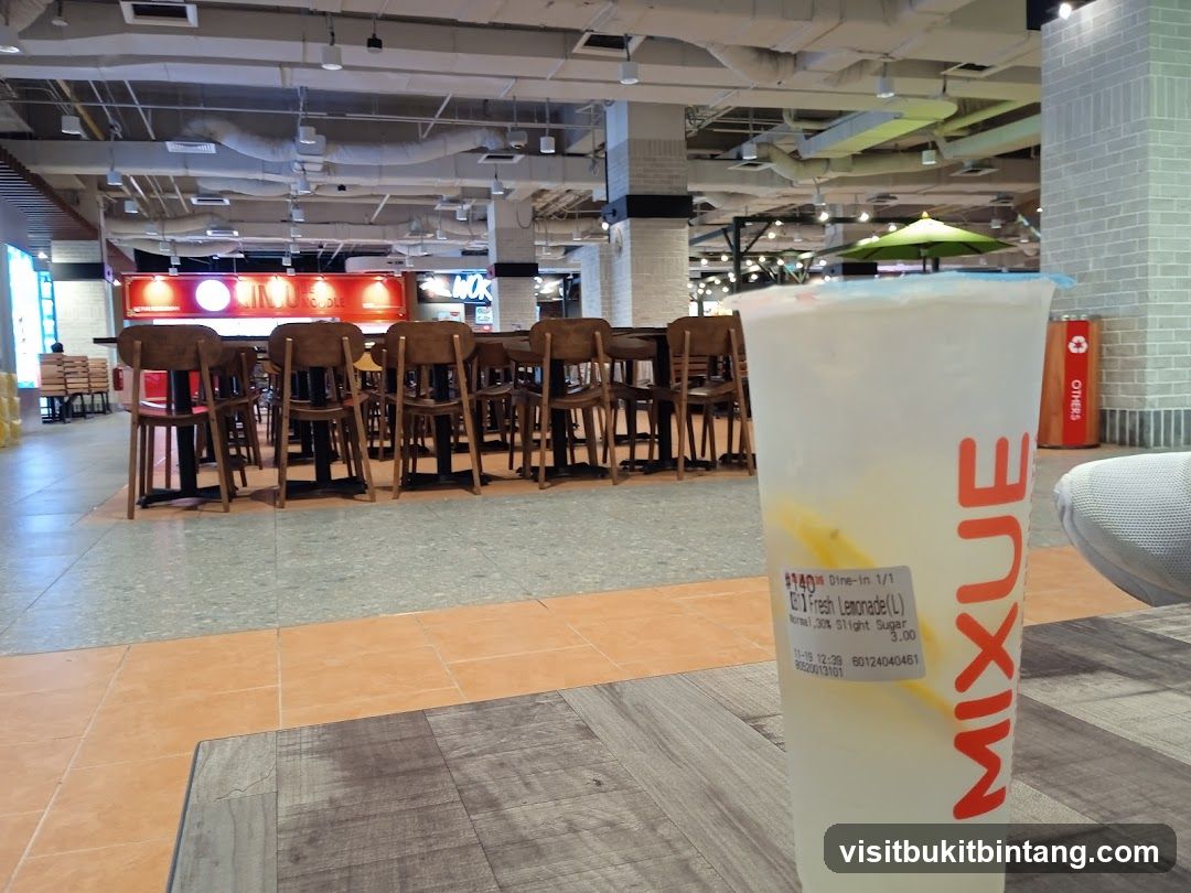 Drink with food court in background