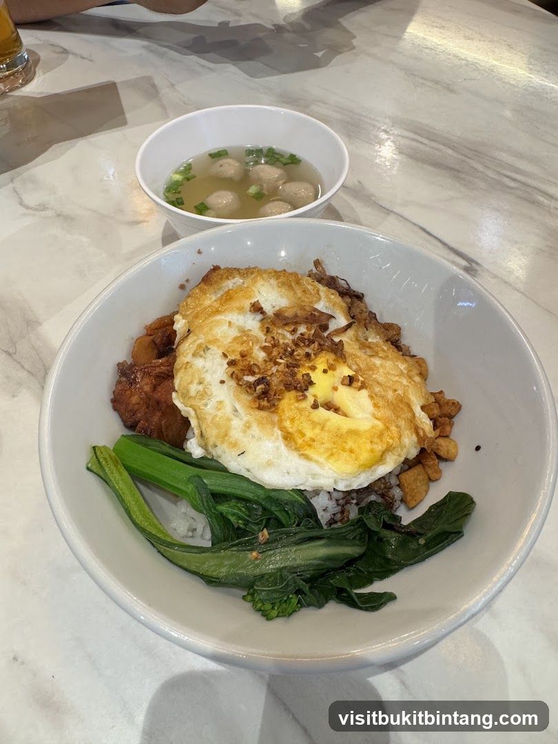 Rice bowl with fried egg and side soup