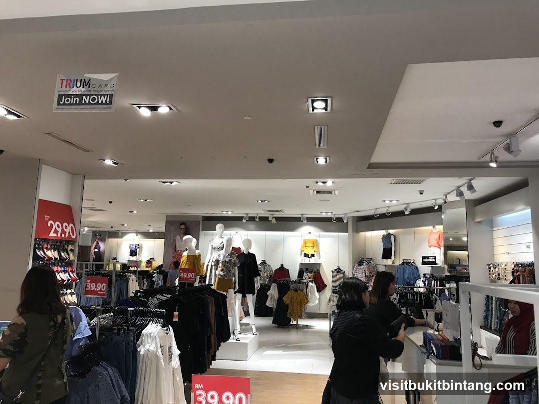 Clothing store interior with mannequins and sale signs