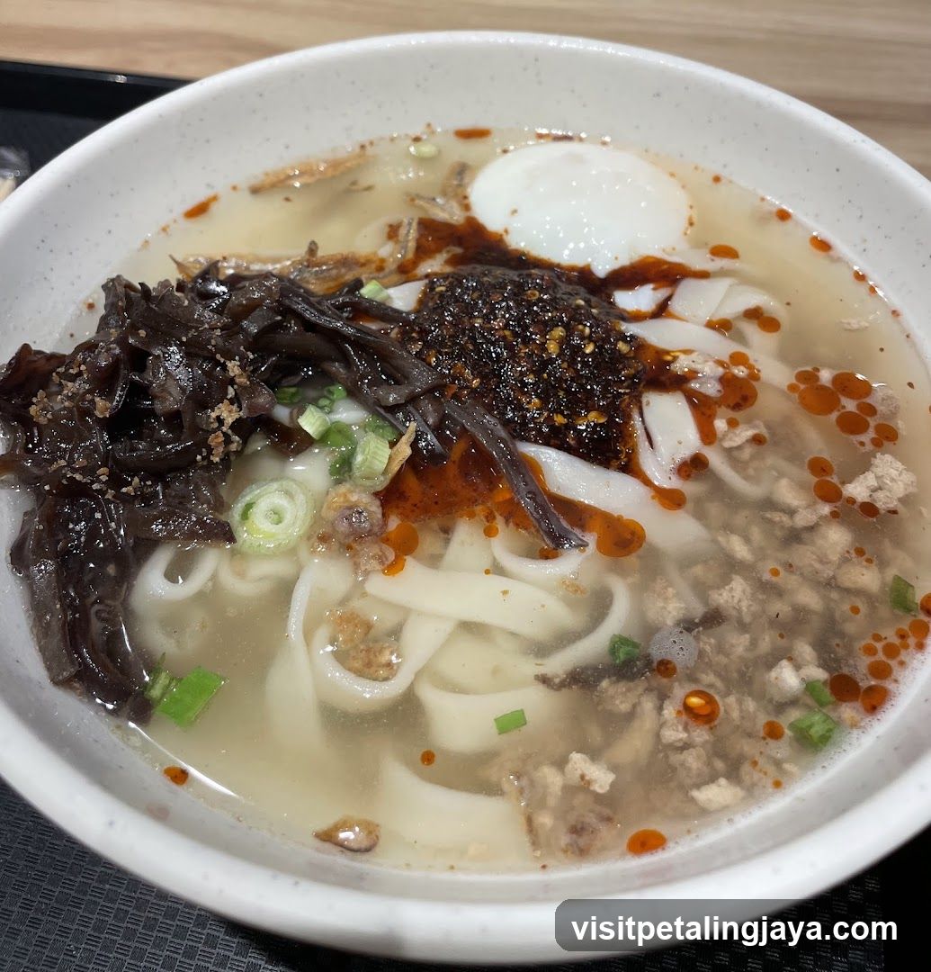 Bowl of Noodle Soup with Egg and Oil