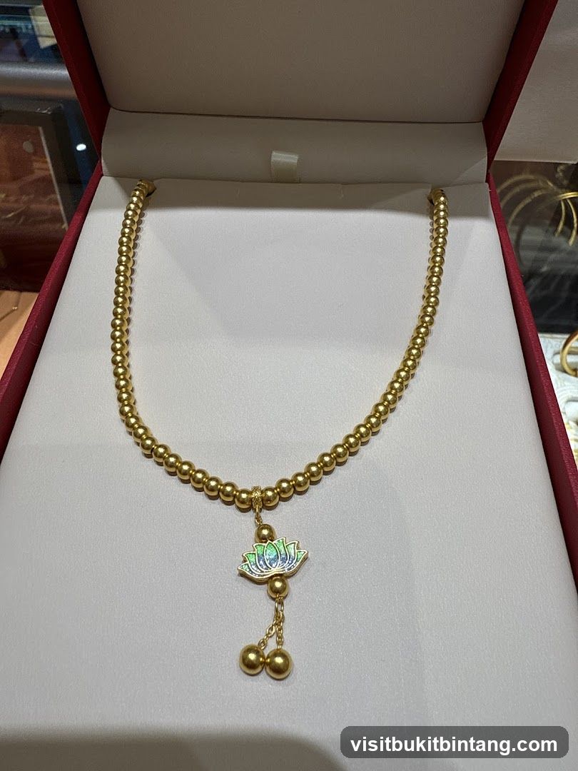 Gold beaded necklace with lotus pendant