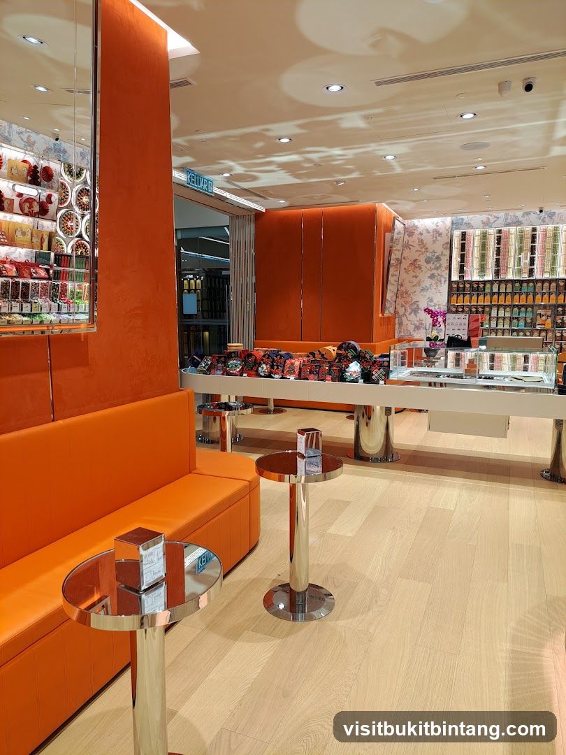 Interior of a brightly lit store with orange seating and display shelves.