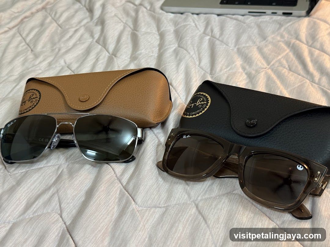 Sunglasses and Cases on Bed
