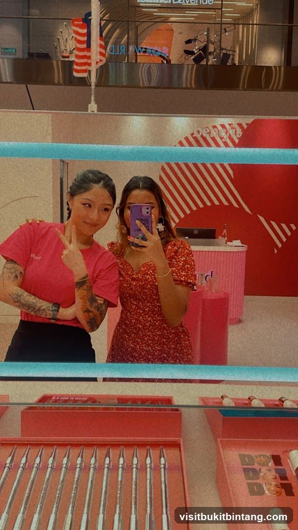 Two women taking a mirror selfie in a store
