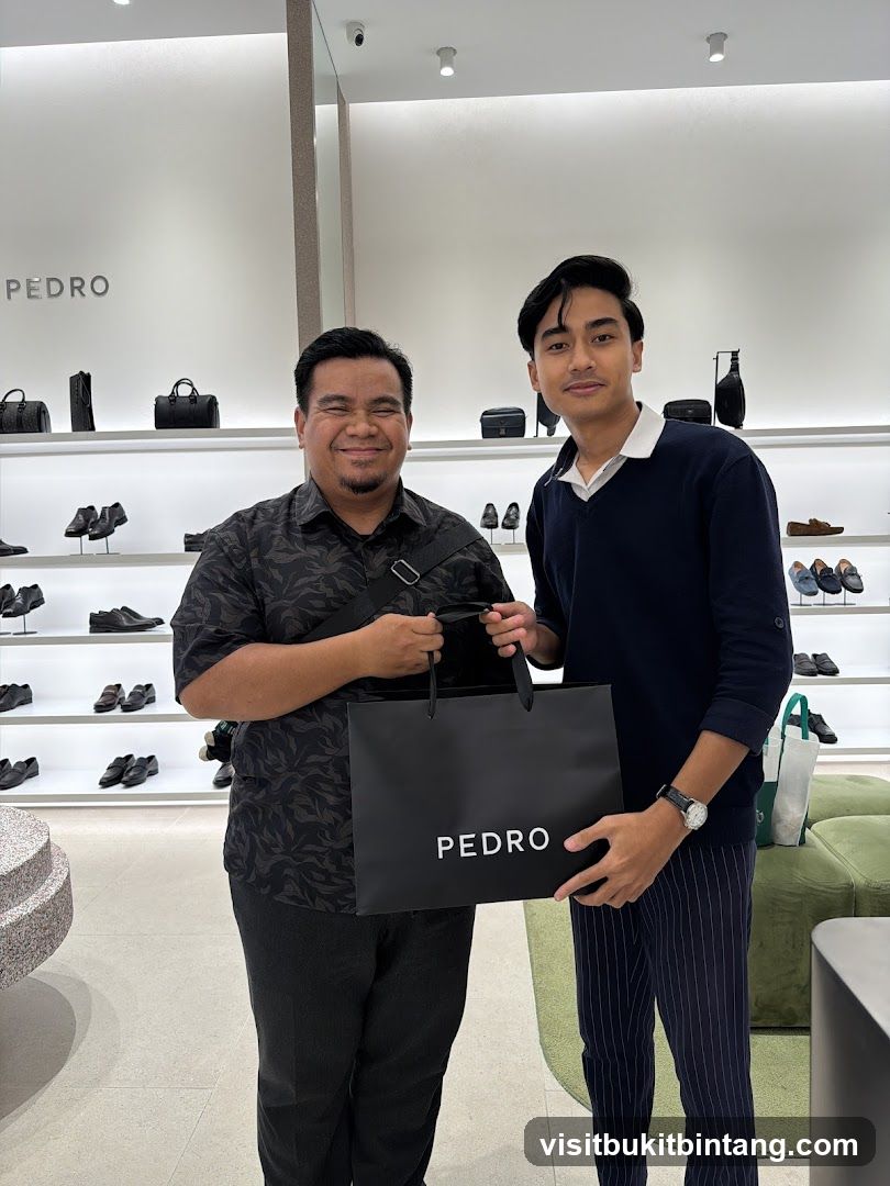 Two men holding a Pedro shopping bag in a store