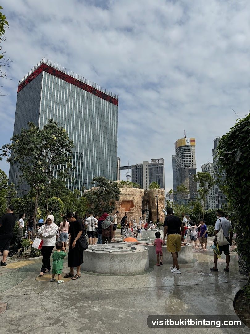 People Enjoying a Water Play Area in a City Park