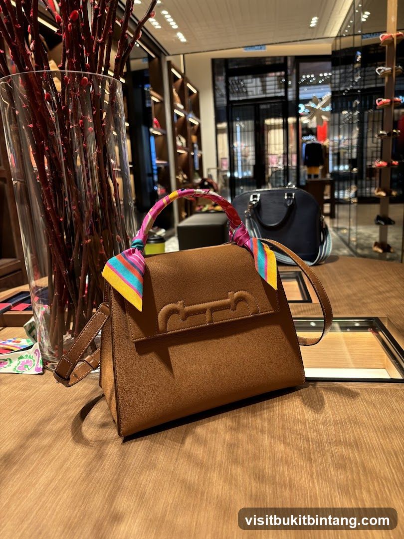 Brown handbag with colorful scarf on display