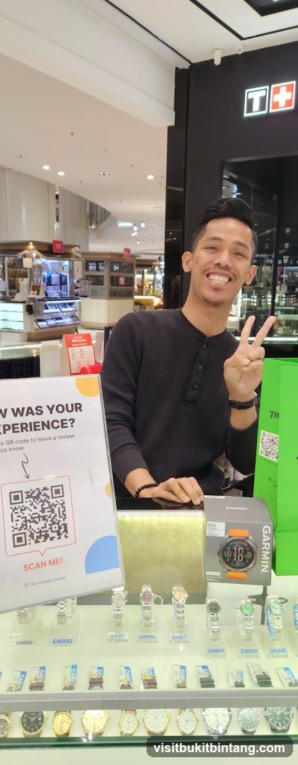 Man posing with watches and Garmin box