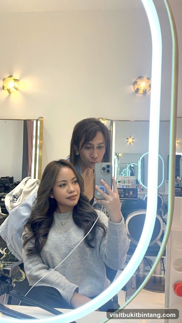 Two people taking a selfie in a salon