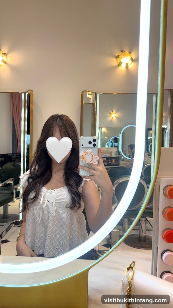 Woman taking a mirror selfie in a salon