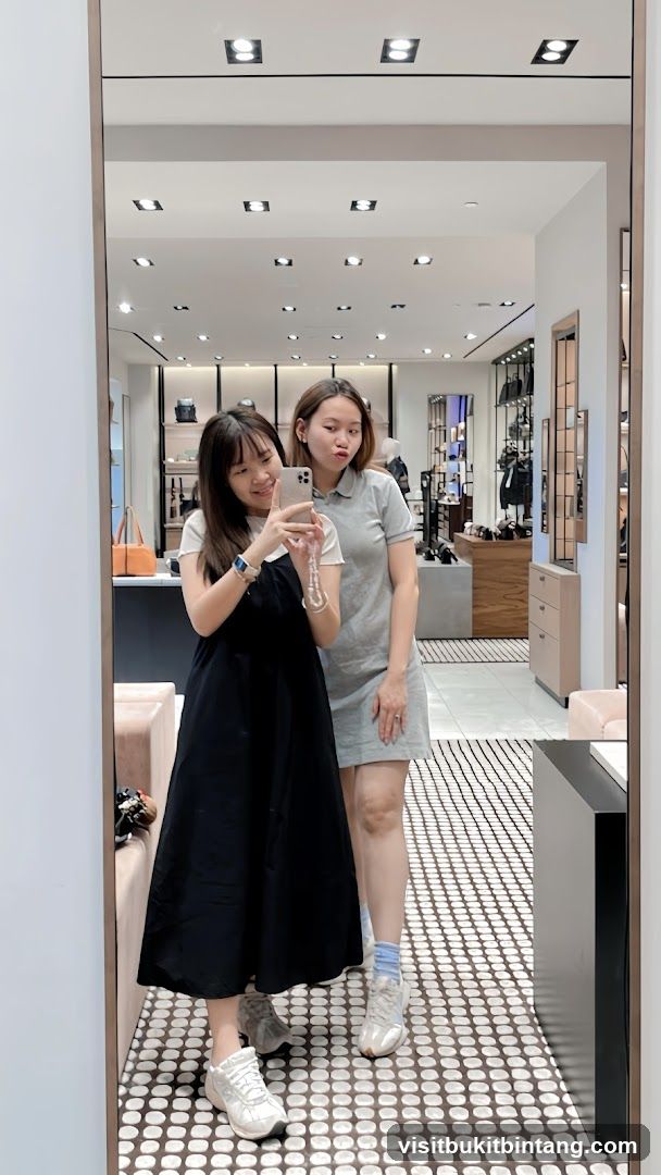 Two Women Taking a Mirror Selfie in a Store