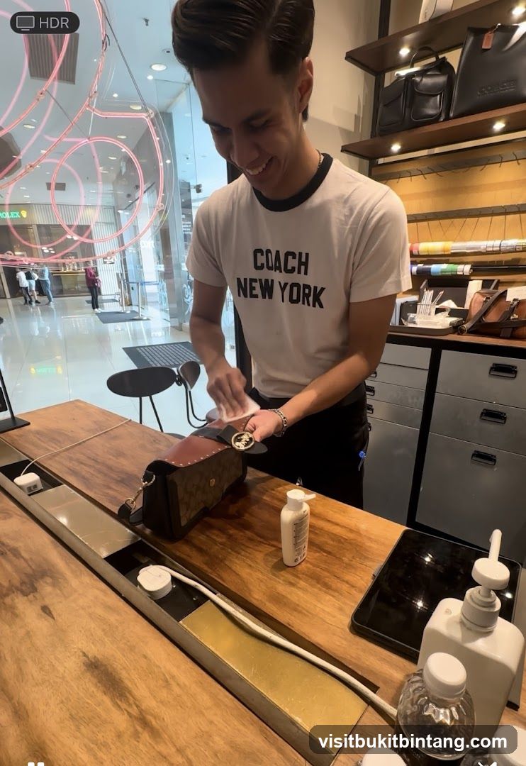 Sales associate cleaning a handbag