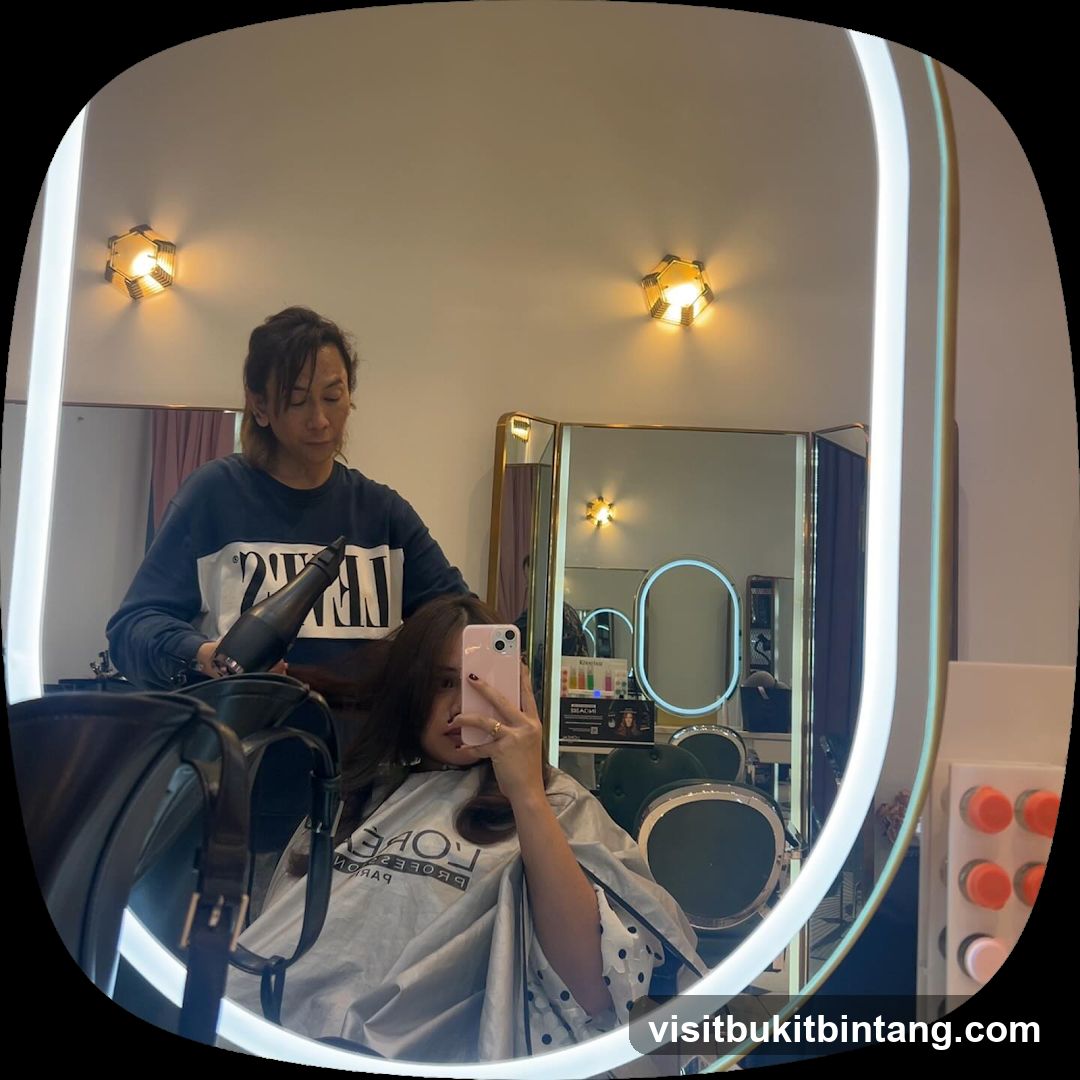 Hairdresser drying client's hair