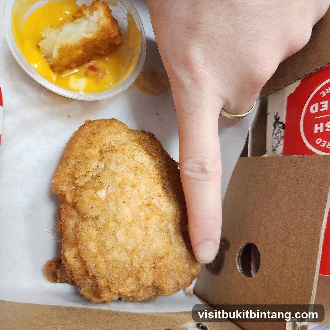 Fried chicken and potato bites with cheese sauce