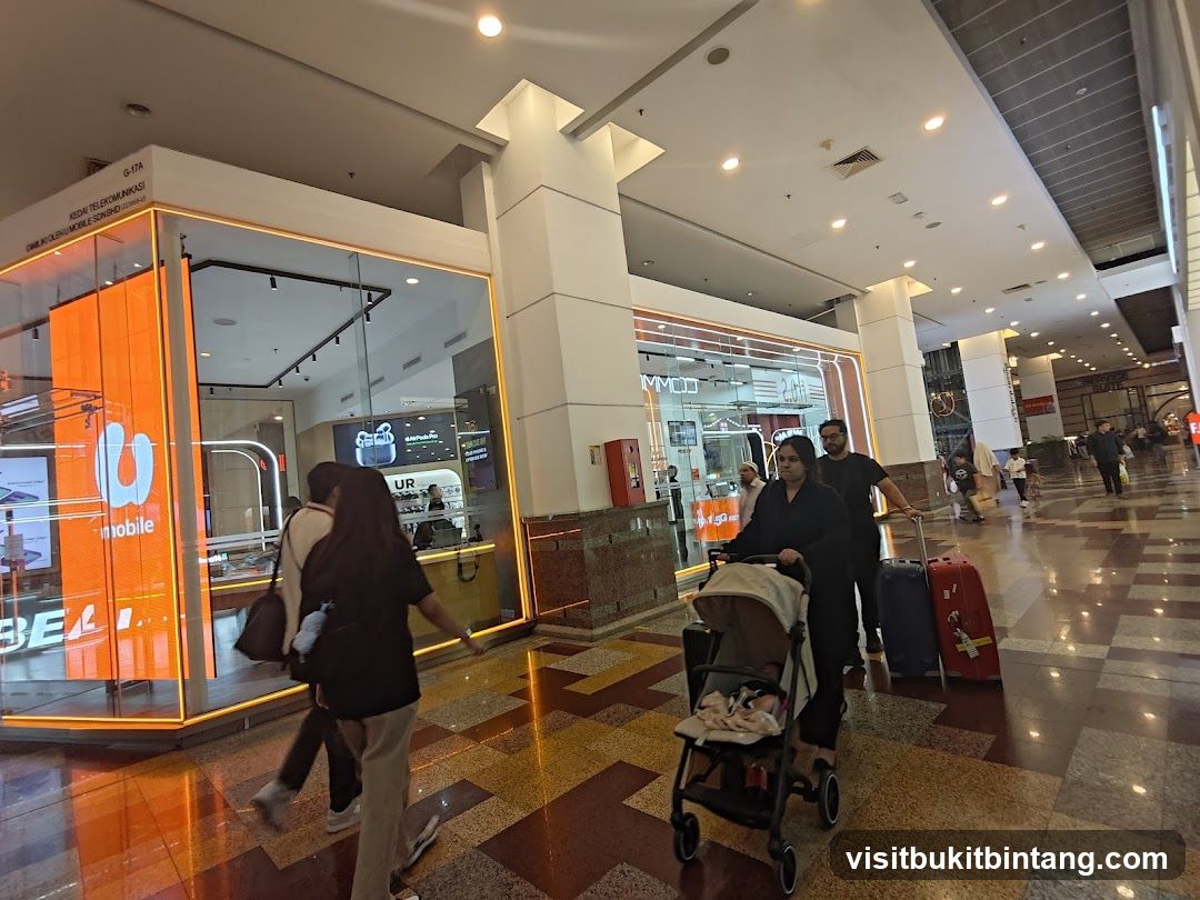 People walking in a mall with a mobile store