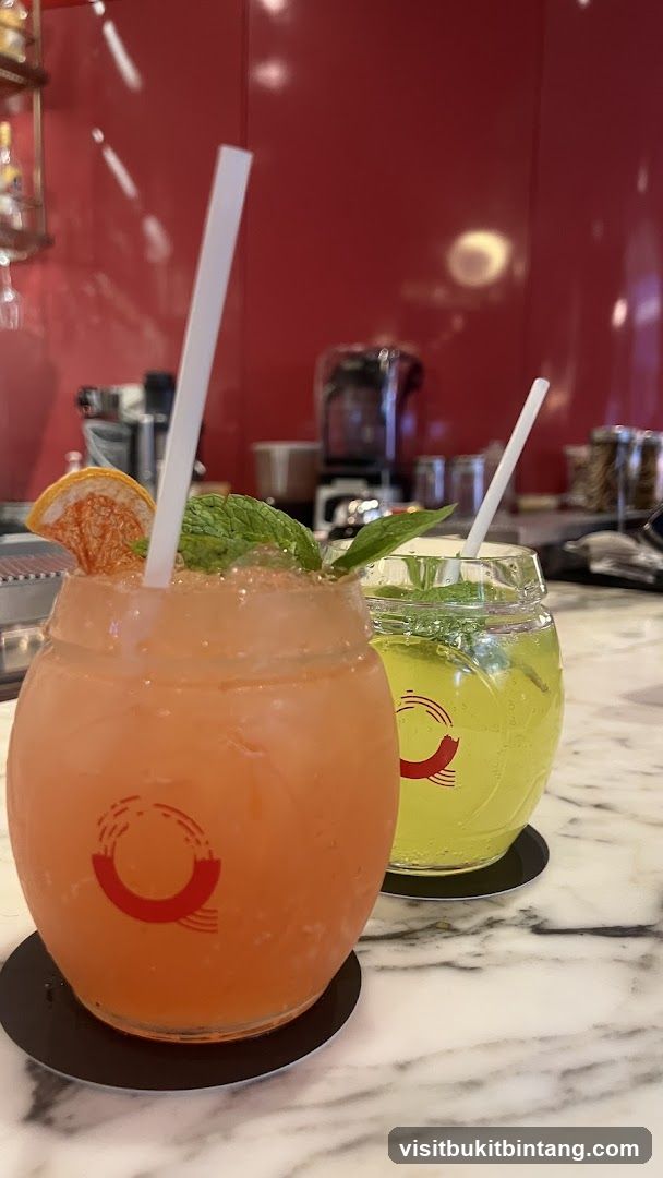 Two colorful cocktails on a marble countertop