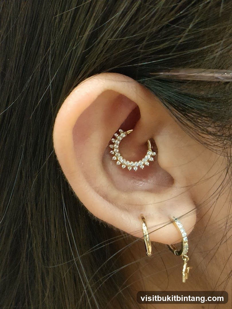 Close-up of a woman's ear with multiple piercings and jewelry