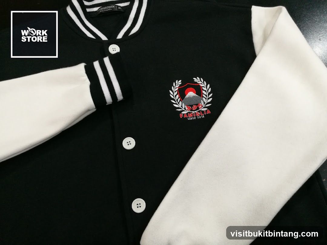 Black and white varsity jacket with embroidered emblem