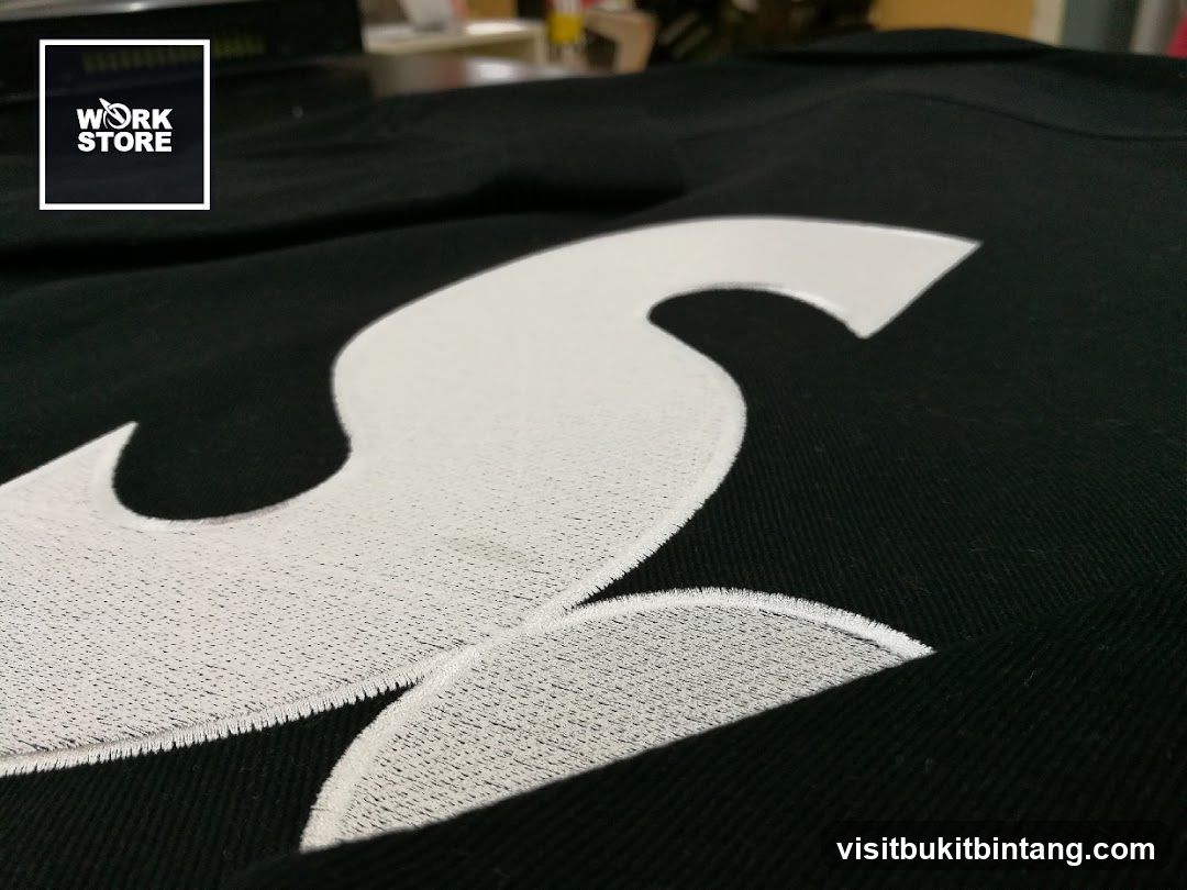 Embroidered Logo on Black Fabric