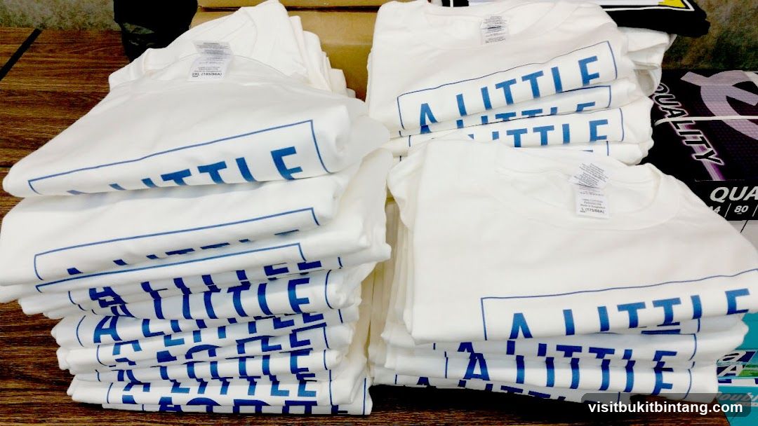 Stacked T-shirts with blue text