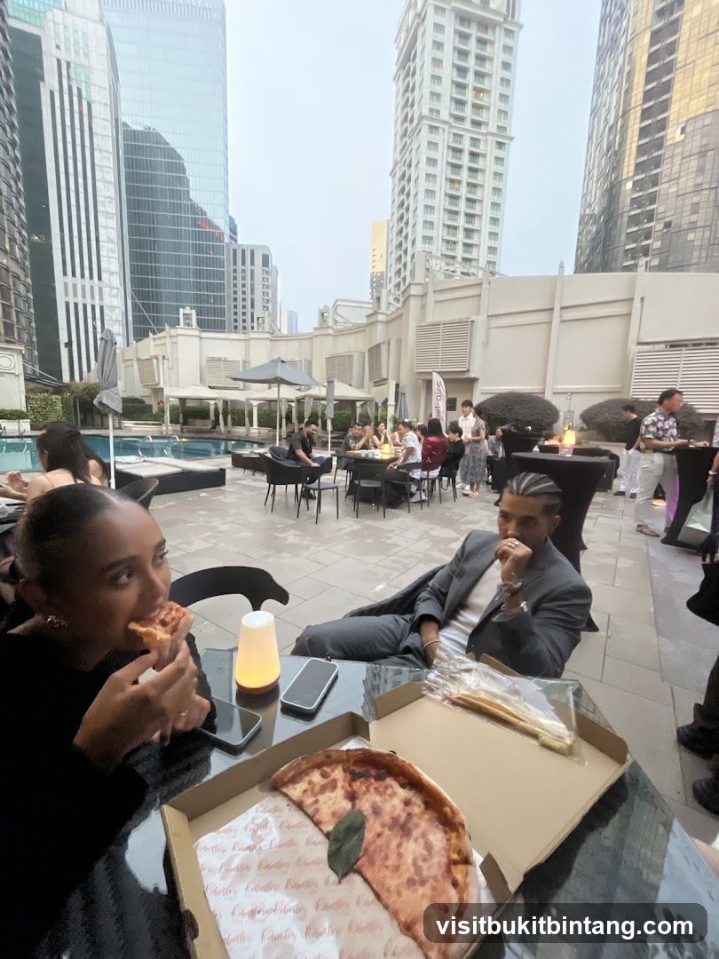 People eating pizza at an outdoor event