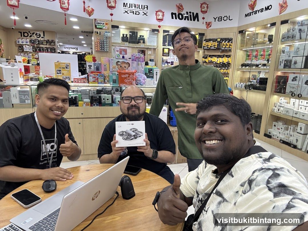 Four men in a camera store
