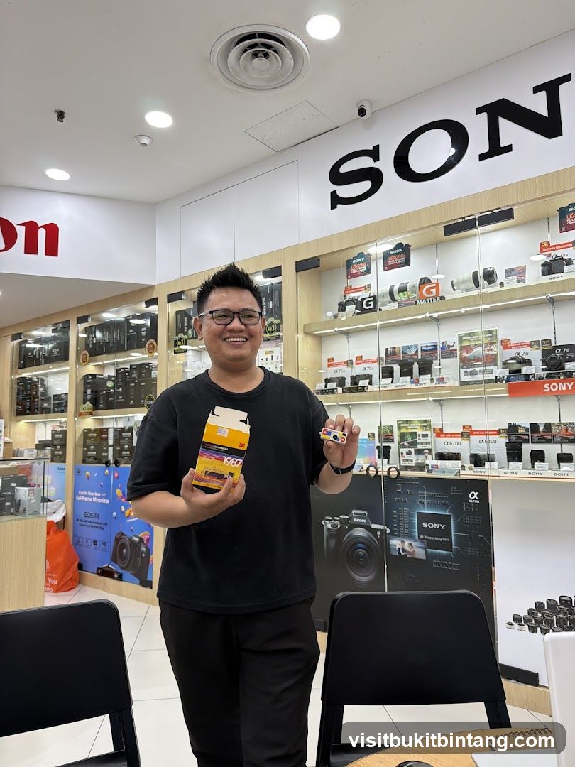 Man holding Kodak film box and a small item