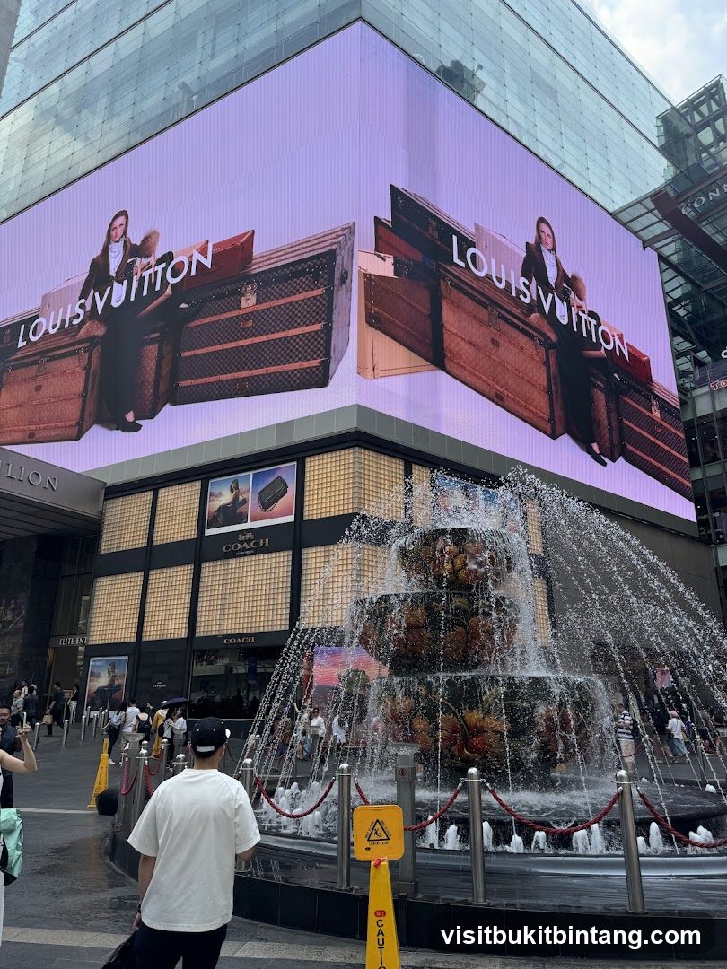 Louis Vuitton and Coach Advertisement with Fountain