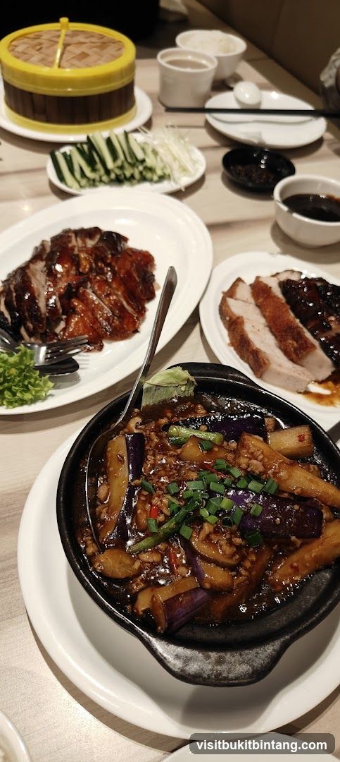 Table with Roasted Duck and Eggplant Dish