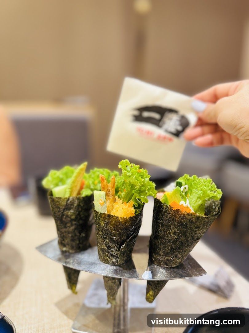 Hand holding a napkin over sushi cones