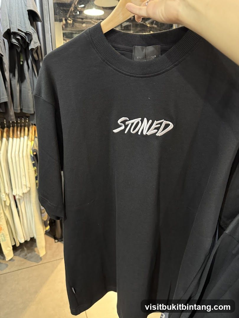Black T-shirt with "STONED" logo