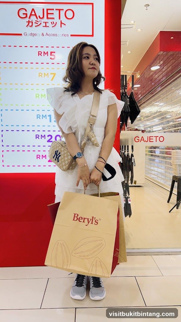 Woman holding shopping bags in front of a store